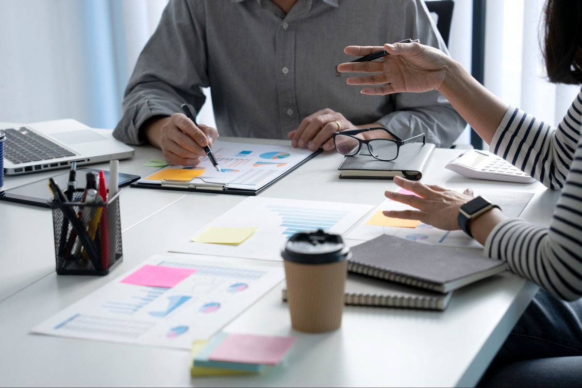 Leadership team discussing strategy and reviewing financial dashboards together